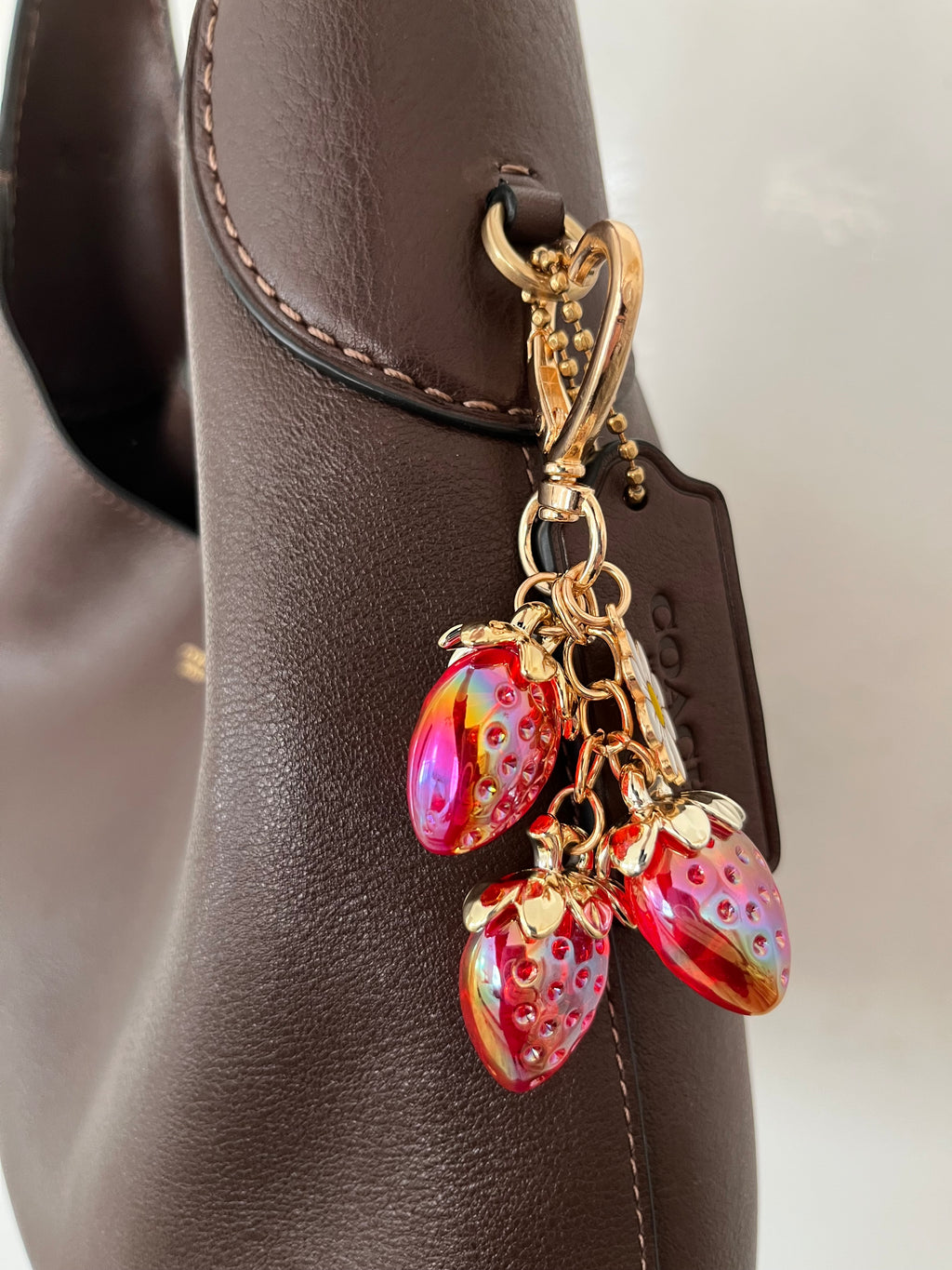 Red strawberry with daisy charm