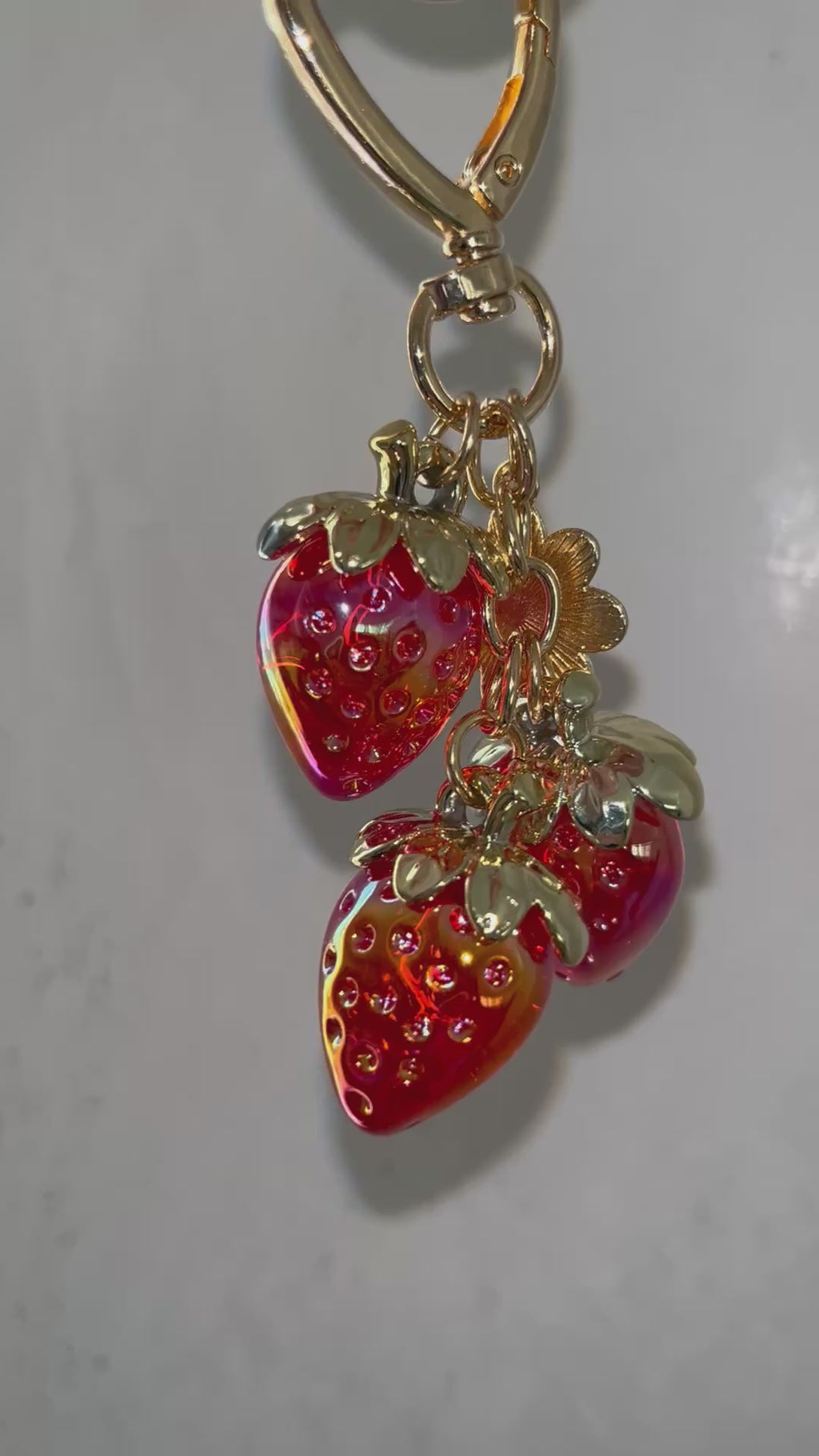 Red strawberry with daisy charm